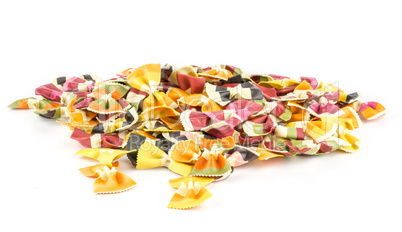 Colourful raw farfalle isolated on white