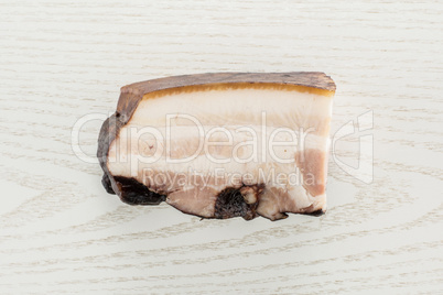 Fresh smoked english bacon on grey wood