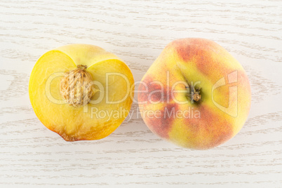 Fresh Raw yellow peach on grey wood