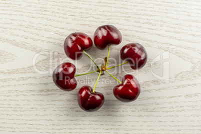 Fresh raw sweet red cherry on grey wood