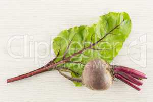 Fresh raw red beetroot on grey wood