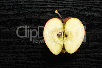 Fresh raw apple red delicious on black wood