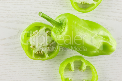 Fresh raw light green pepper on grey wood