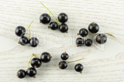 Fresh Raw Black Currant berry on grey wood