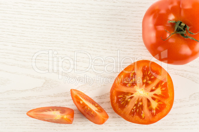 Fresh raw Tomato (La Parcela variety) on grey wood