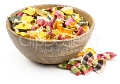 Colourful raw farfalle isolated on white