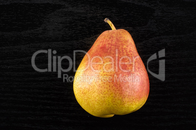 Fresh Raw red pear on black wood