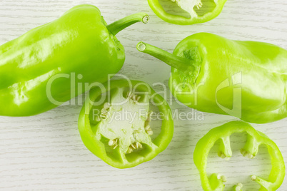 Fresh raw light green pepper on grey wood