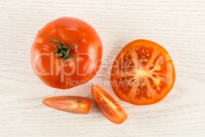 Fresh raw Tomato (La Parcela variety) on grey wood