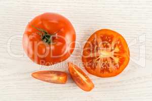 Fresh raw Tomato (La Parcela variety) on grey wood