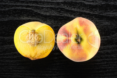 Fresh Raw yellow peach on black wood