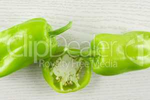 Fresh raw light green pepper on grey wood