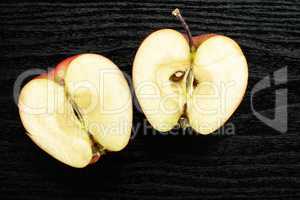 Fresh raw apple red delicious on black wood