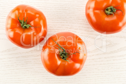 Fresh raw Tomato (La Parcela variety) on grey wood