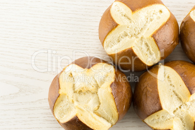 Fresh Bavarian bread bun on grey wood