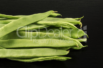 Fresh Flat Green Bean on black wood