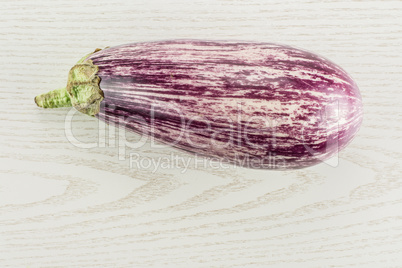 Fresh raw striped Eggplant on grey wood