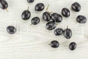 Fresh Black Wine Grapes on grey wood