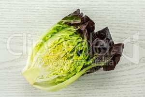 Fresh raw lettuce red little gem on grey wood