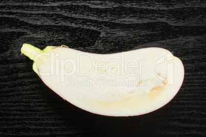 Fresh raw striped Eggplant on black wood