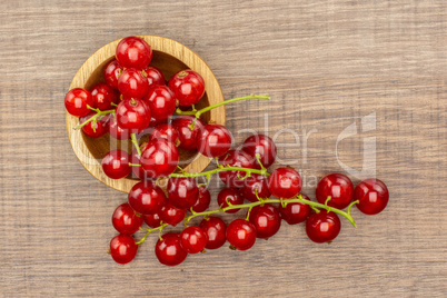 Fresh raw red currant on brown wood