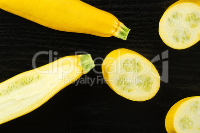 Fresh Raw yellow zucchini on black wood