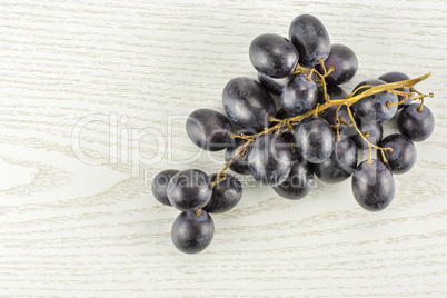 Fresh Black Wine Grapes on grey wood
