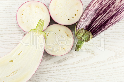 Fresh raw striped Eggplant on grey wood