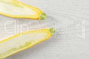Fresh Raw yellow zucchini on grey wood