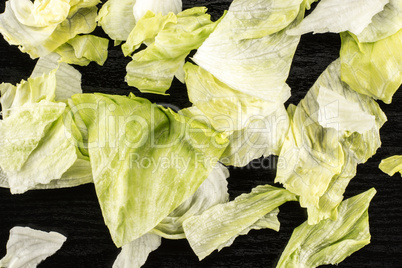 Fresh Raw Iceberg Lettuce on black wood