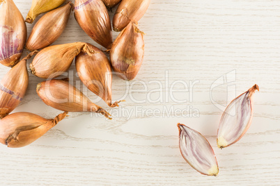 Fresh raw long shallot onion on grey wood