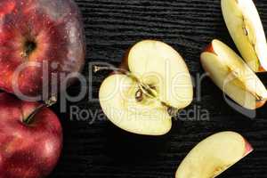 Fresh raw apple red delicious on black wood
