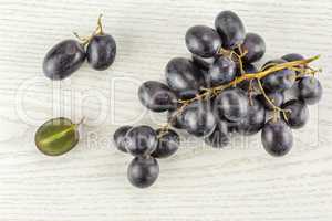 Fresh Black Wine Grapes on grey wood