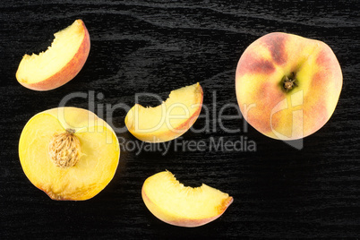 Fresh Raw yellow peach on black wood