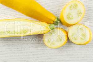 Fresh Raw yellow zucchini on grey wood