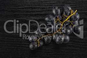 Fresh Black Wine Grapes on Black wood