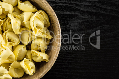 Fresh Raw tortellini pasta on black wood
