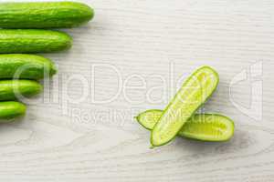 Fresh raw mini cucumber on grey wood