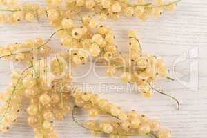 Fresh white currant berries on grey wood