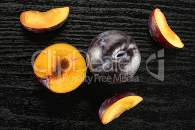 Red Blue Plums on black wood