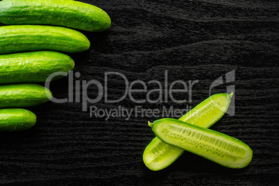 Fresh raw mini cucumber on black wood