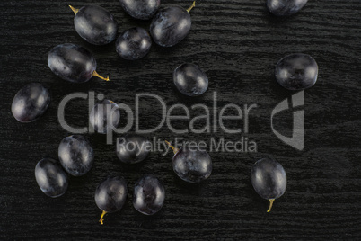 Fresh Black Wine Grapes on Black wood