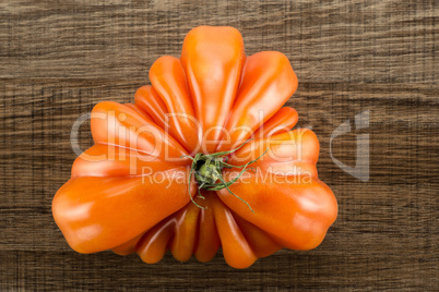 Fresh Raw Beef Tomato on brown wood