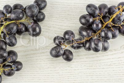 Fresh Black Wine Grapes on grey wood