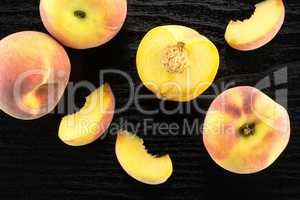 Fresh Raw yellow peach on black wood