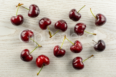 Fresh raw sweet red cherry on grey wood