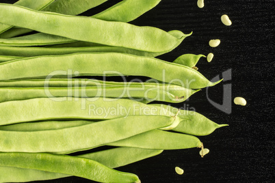 Fresh Flat Green Bean on black wood