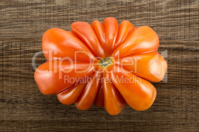 Fresh Raw Beef Tomato on brown wood