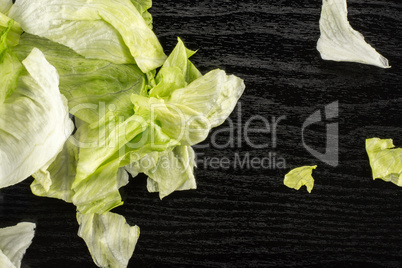 Fresh Raw Iceberg Lettuce on black wood