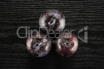 Red Blue Plums on black wood